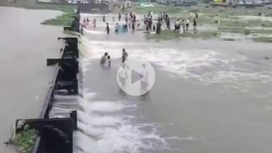 हुज़ूर: भोपाल: आनंद नगर डैम पर बहते पानी में जान जोखिम में डालकर मछली पकड़ रही भीड़