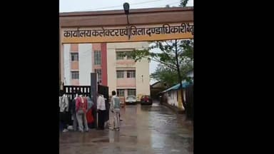 पहली बारिश में डूबा कलेक्ट्रेट का मुख्य गेट, जनसुनवाई में पहुंचे लोगों को तालाब पार कर पहुंचना पड़ा
बैतूल में पहली तेज बारिश ने खोली प्रशासनिक तैयारियों की पोल, कलेक्ट्रेट गेट पर भरा तालाब
बैतूल जिला मुख्यालय पर मंगलवार दोपहर करीब 2 बजे हुई तेज बारिश ने प्रशासनिक व्यवस्थाओं की पोल खोल दी। बारिश के कुछ ही देर बाद कलेक्ट्रेट कार्यालय के मुख्य गेट पर भारी जलभराव हो गया, जिससे पूरा परिसर तालाब जैसा नजर आने लगा।
मंगलवार को आयोजित होने वाली जनसुनवाई में अपनी समस्याएं लेकर पहुंचे लोगों को पानी से होकर गुजरना पड़ा। आवेदकों ने बताया कि कलेक्ट्रेट जैसे महत्वपूर्ण सरकारी कार्यालय के प्रवेश द्वार पर जलभराव होना गंभीर लापरवाही को दर्शाता है।
स्थानीय लोगों का कहना है कि यह बारिश का पहला दौर है, और अगर अभी से ये हालात हैं तो आने वाले मानसून में स्थिति और भी भयावह हो सकती है।
लोगों ने प्रशासन से कलेक्ट्रेट परिसर के सामने जल निकासी की स्थायी व्यवस्था करने की मांग की है, ताकि आम नागरिकों को परेशानी का सामना न करना पड़े।
#MadhyaPradesh #RainAlert #MonsoonUpdate #Waterlogging #Administration #PublicIssue #ViralNews #TrendingNow #GroundReport #CitizenVoice