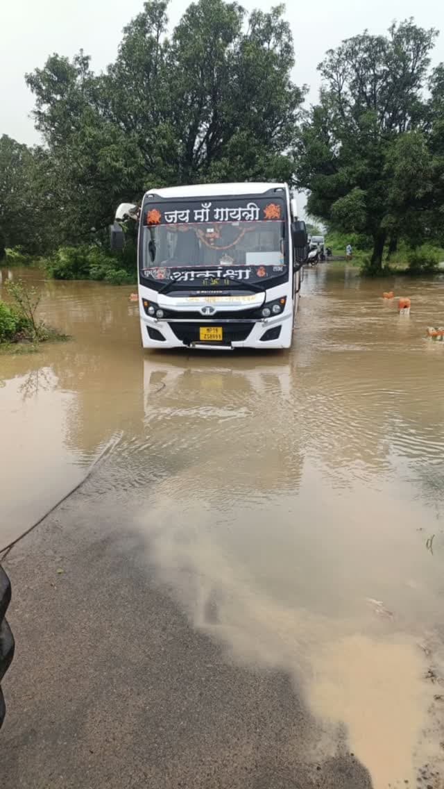 यात्रियों ने रोका, फिर भी उफनते रपटे पर बस बढ़ाई; फंसी तो चालक भागा
सतना। मैहर जिले के ताला थाना क्षेत्र में बस चालक की गंभीर लापरवाही से करीब दो दर्जन यात्रियों की जान खतरे में पड़ गई। गुरुवार दोपहर खजुरी से रामगढ़ जा रही MP 19 ZB 8999 बस जब बिधुई खुर्द रपटे पर पहुंची तो तेज बहाव के कारण पानी कई फीट ऊपर से बह रहा था। यात्रियों ने चालक को बस आगे न ले जाने के लिए रोका, लेकिन उसने खतरे की अनदेखी कर बस रपटे पर उतार दी।
कुछ दूर जाते ही तेज बहाव के कारण बस का इंजन बंद हो गया और बस पुलिया के बीच फंस गई। यात्रियों में चीख-पुकार मच गई। हालात बिगड़ते देख चालक यात्रियों को बस में ही छोड़कर अपनी जान बचाकर मौके से भाग निकला।
सूचना पर पहुंची ताला पुलिस ने ट्रैक्टर की मदद से बस को सुरक्षित बाहर निकलवाया। घटना का वीडियो वायरल होने के बाद एसपी अवधेश प्रताप सिंह के निर्देश पर चालक के खिलाफ BNS की धारा 110 में गैर इरादतन हत्या का केस दर्ज किया गया। पुलिस चालक का लाइसेंस तथा ब