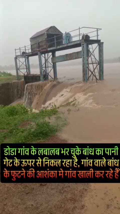 डोडा गांव के लबालब भर चुके बांध का पानी गेट के ऊपर से निकल रहा है, गांव वाले बांध के फुटने की आशंका मे गांव खाली कर रहे हैँ