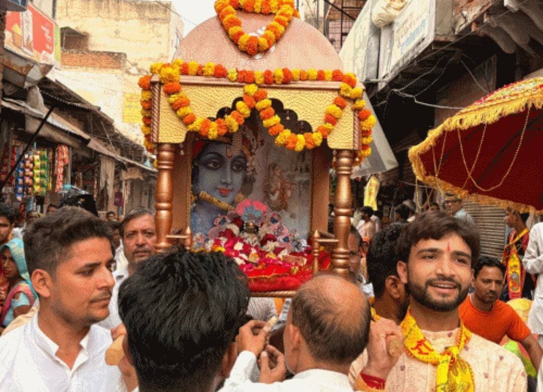 #भरतपुर। जलझूलनी एकादशी के पावन अवसर पर मंगलवार को बयाना कस्बा पूरी तरह भक्ति के रंग में रंगा नजर आया। शहर के ऐतिहासिक शिवगंज मंडी रोड स्थित बिहारीजी मंदिर और भीतरबाड़ी के श्री गोविंद देव मंदिर से ठाकुरजी की अत्यंत भव्य एवं आकर्षक डोल यात्राएं निकाली गईं। फूलों से सजी सुंदर पालकी में ठाकुरजी का अलौकिक श्रृंगार कर उन्हें नई पोशाक धारण कराई गई थी। शोभायात्रा के दौरान वृंदावन के इस्कॉन मंदिर से आए देशी-विदेशी कृष्ण भक्तों द्वारा वाद्य यंत्रों की धुन पर किए गए गोपी नृत्य, इत्र वर्षा, महाकाल की झांकी और ग्वालियर के खलील धमाल बैंड की प्रस्तुति ने श्रद्धालुओं को भावविभोर कर दिया। शहरभर में जगह-जगह पुष्प वर्षा कर यात्रा का स्वागत किया गया और श्रद्धालुओं में पालकी के नीचे से निकलने की होड़ लगी रही। इसी क्रम में यदुवंशी सैनी समाज द्वारा भीतरबाड़ी स्थित श्री गोविंद देव मंदिर से भव्य डोल यात्रा निकाली गई, जो पठानपाड़ा, कोली मोहल्ला, गांधी चौक और मुख्य बाजार से होते हुए गुजरी। इस दौरान सैनी समाज अध्यक्ष रामेश्वर सैनी ने इस परंपरा को सामाजिक आस्था और भाईचारे का प्रतीक बताया।