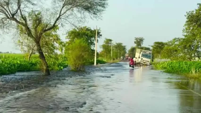 लहरपुर: लहरपुर में बाढ़ का कहर, सड़क के किनारे भरे पानी में डूबी बाइक, डीसीएम पलटने से बाल-बाल बची